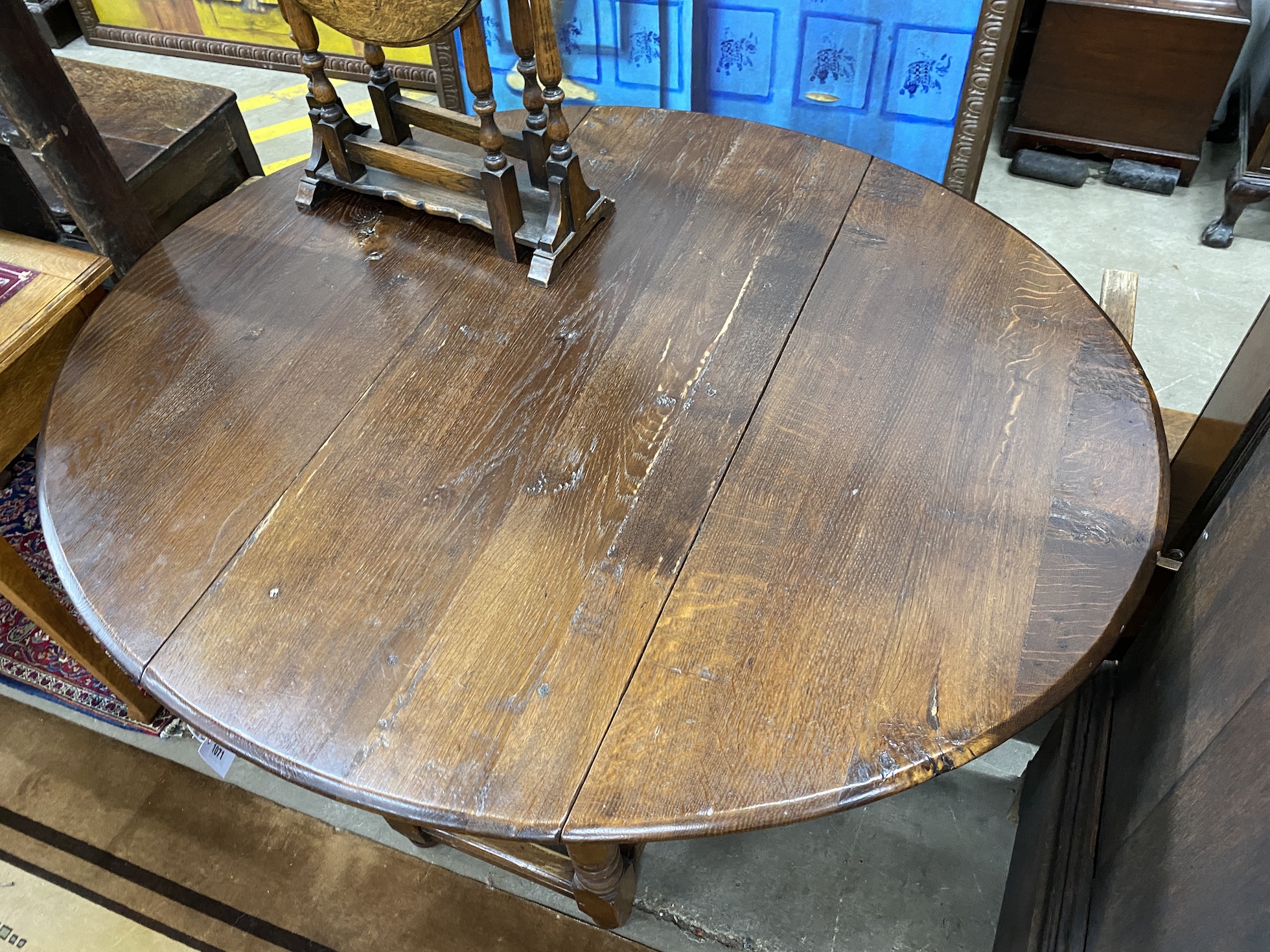 An 18th century style oak gateleg dining table, 140cm extended, depth 120cm, height 73cm
